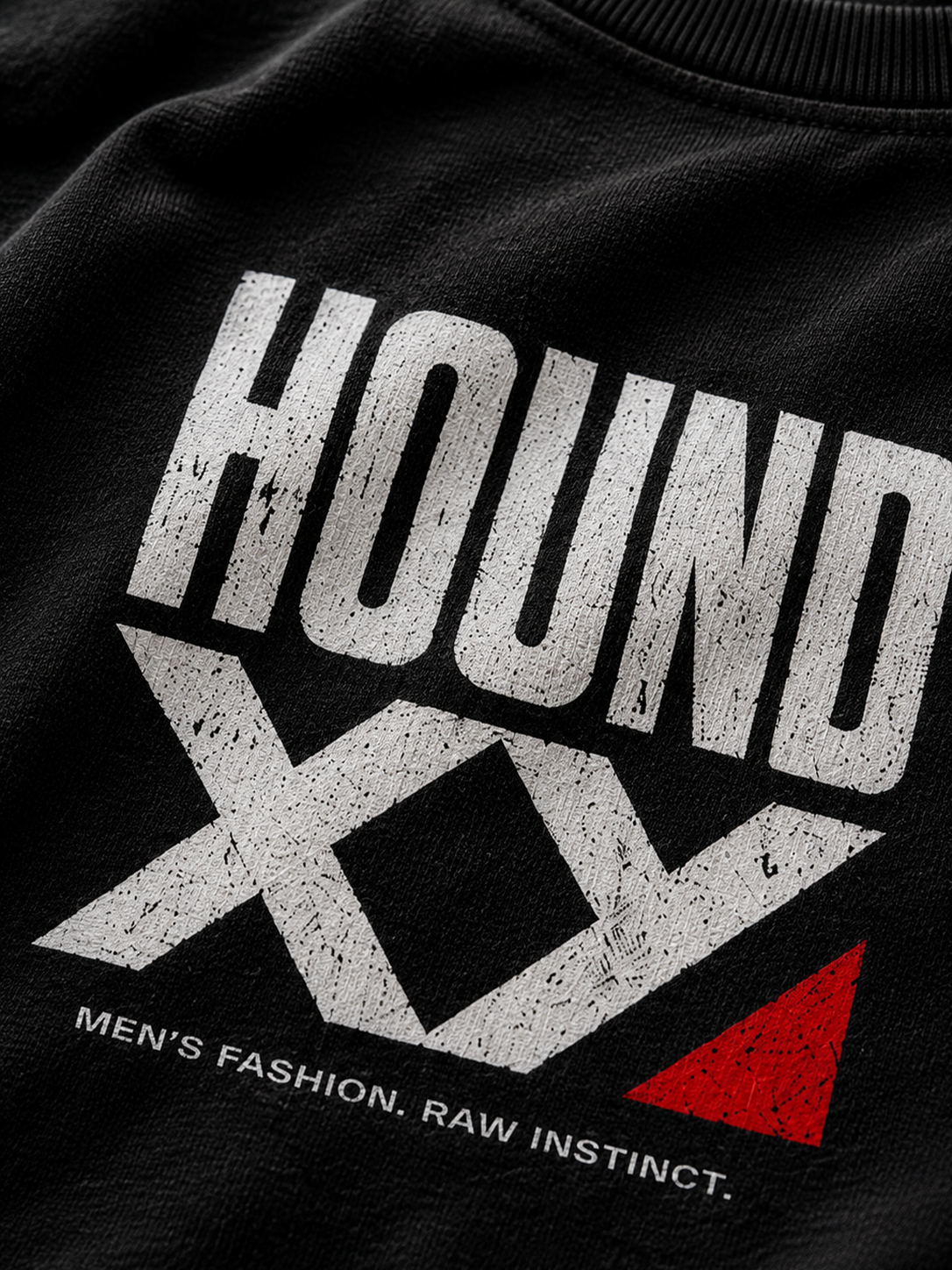 Close-up of a black crewneck sweatshirt featuring a distressed white graphic that reads 'HOUND XY' with a small red triangle accent and the text 'MEN'S FASHION. RAW INSTINCT